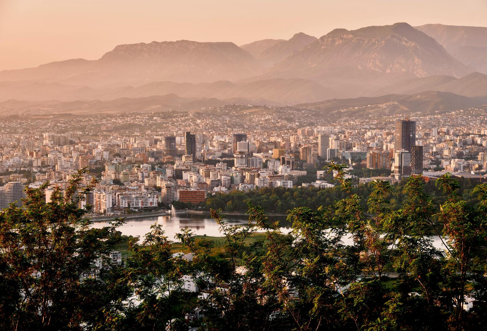 Tirana cityscape aerial view with colorful buildings and mountain backdrop